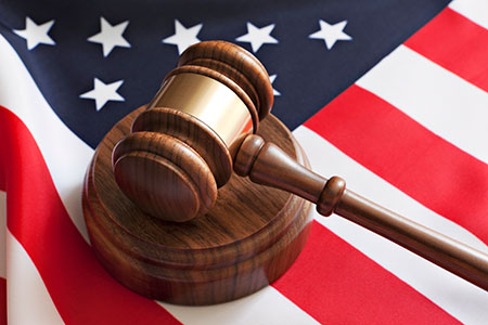 A gavel lying on top of an American Flag