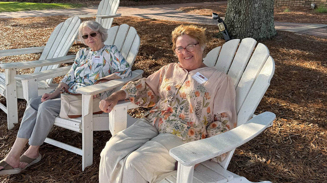 alumni relaxing by the beach