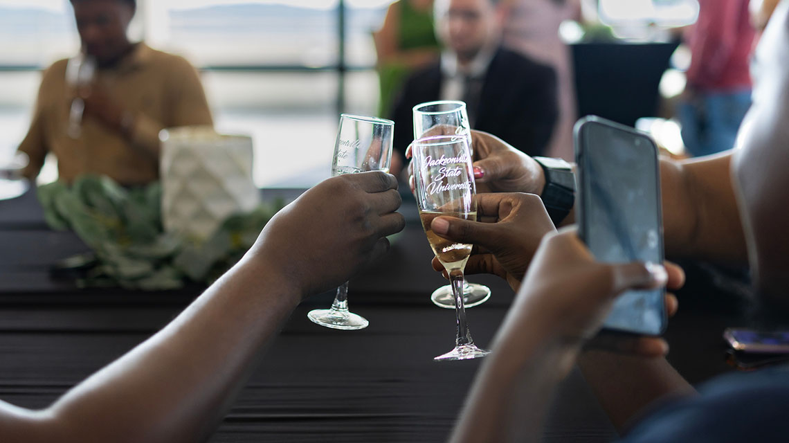 graduates toasting