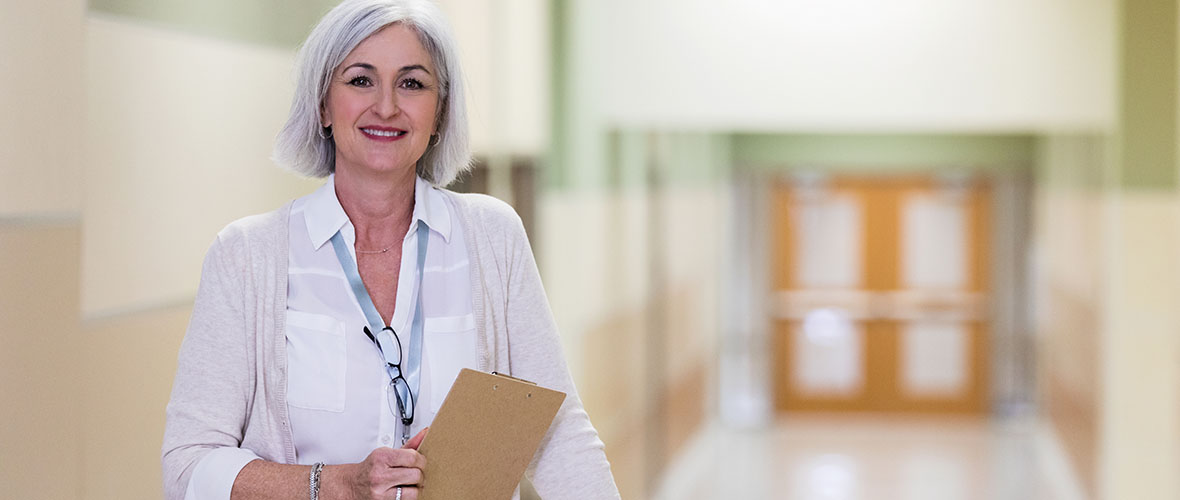 School Principal standing in hallway