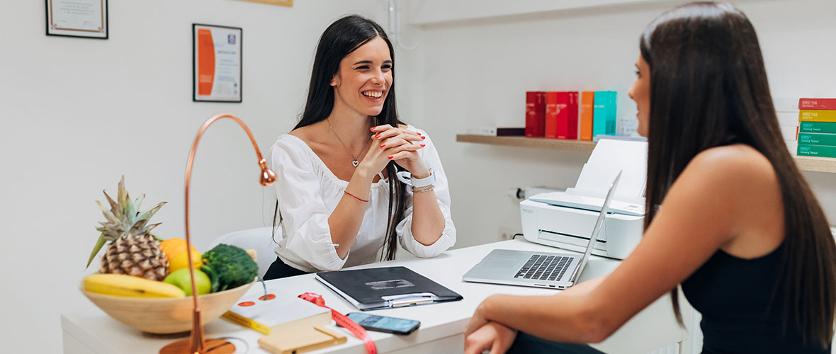 Nutritionist works with client at desk