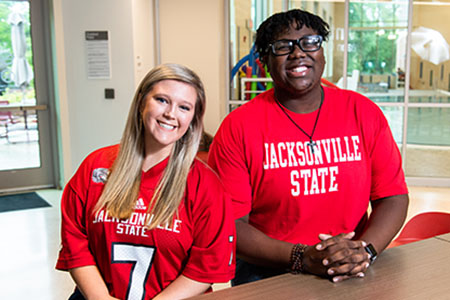 Two students at UREC showing their JSU spirit