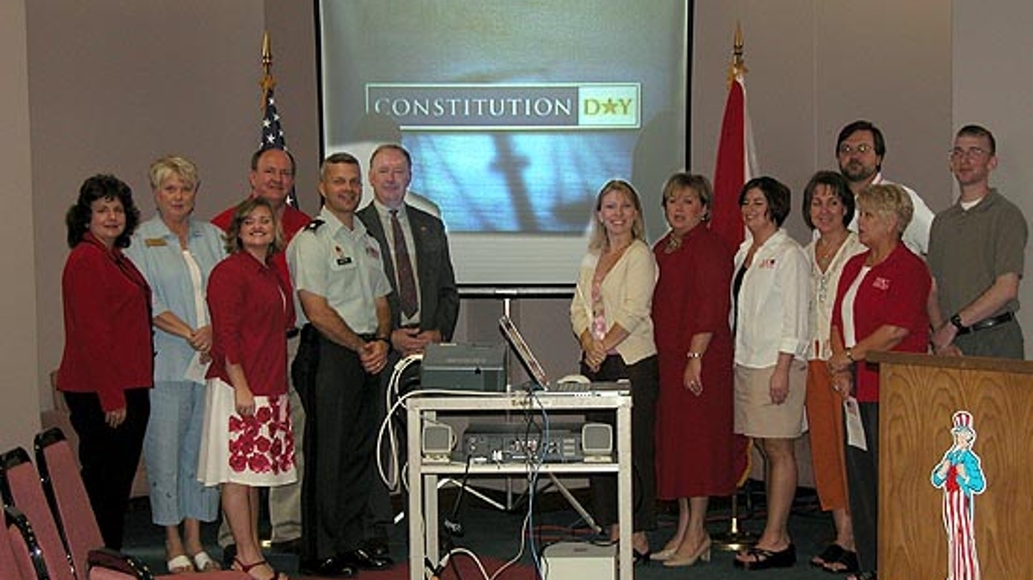 Organizers for the 2005 Constitution Day Program at JSU stand in front of a screen with the text "Constitution Day" showing.