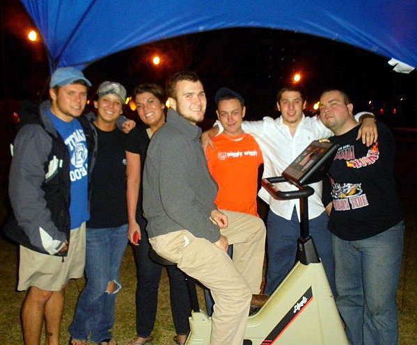 Robinson rides a bike as part of a fraternity fundraiser