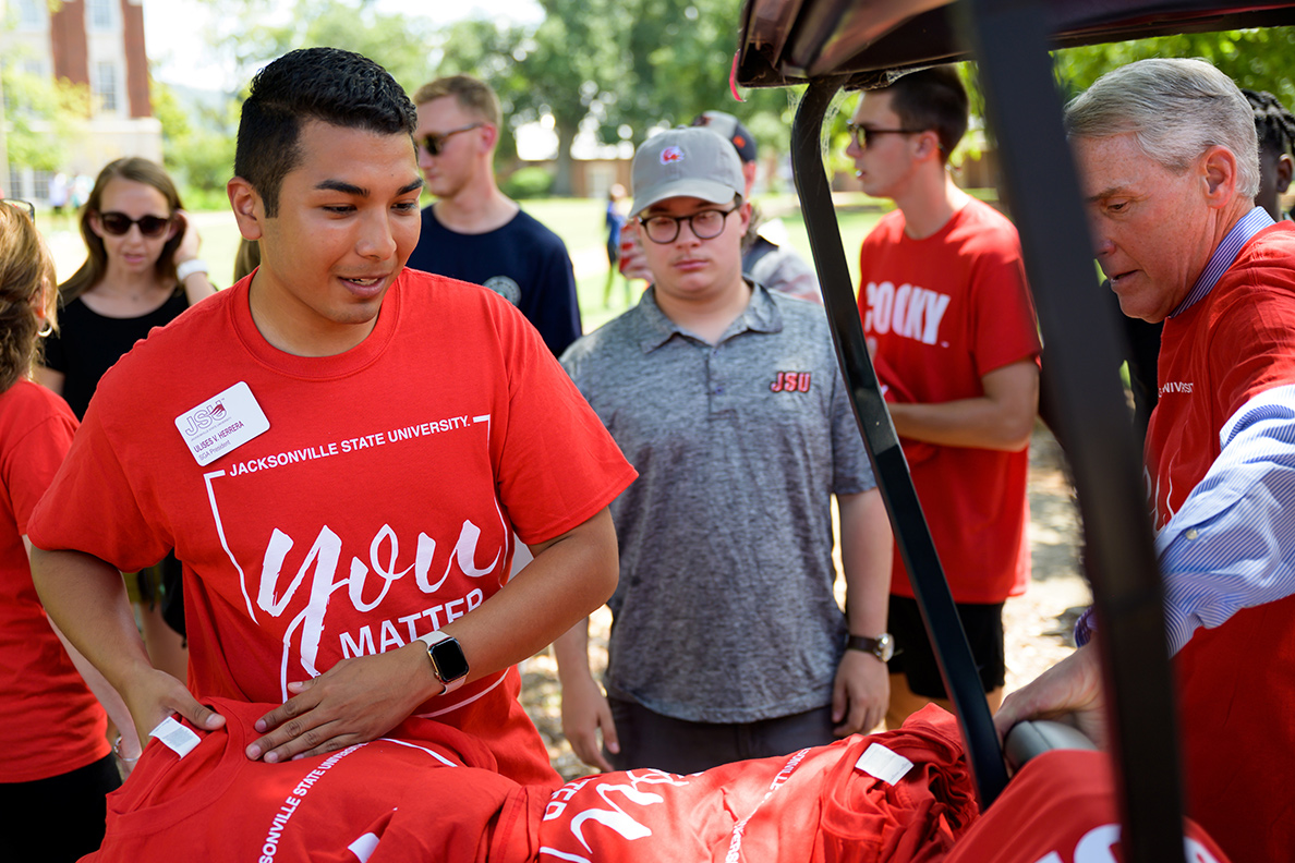 Ulises Herrera giving out tee shirts